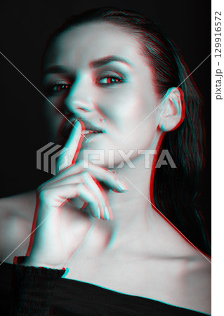 Beautiful woman with dark hair and blouse close-up studio portrait in RGB color split effect style Beautiful woman with dark hair and blouse close-up studio portrait in RGB color split effect style 129916572