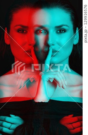 Beautiful woman with dark hair and blouse close-up studio portrait in RGB color split effect style Beautiful woman with dark hair and blouse close-up studio portrait in RGB color split effect style 129916576
