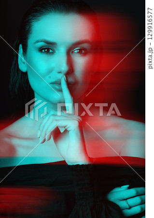 Beautiful woman with dark hair and blouse close-up studio portrait in RGB color split effect style 129916577