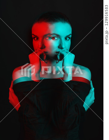 Beautiful woman with dark hair and blouse close-up studio portrait in RGB color split effect style Beautiful woman with dark hair and blouse close-up studio portrait in RGB color split effect style 129916583