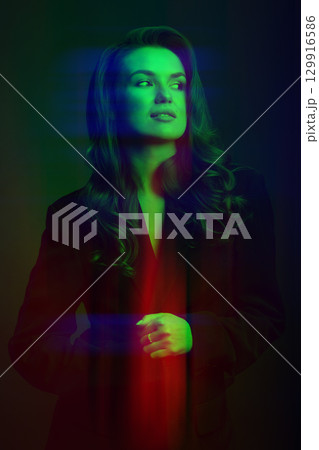Beautiful woman with dark suit and wavy hair studio portrait in RGB color channel split effect style Beautiful woman with dark suit and wavy hair studio portrait in RGB color channel split effect style 129916586