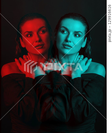 Seductive looking woman with dark clothes and wet hair studio portrait in RGB color split style Seductive looking woman with dark clothes and wet hair studio portrait in RGB color split style 129916616