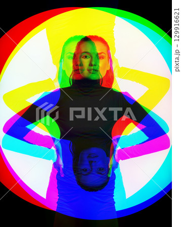 Woman with black turtle neck sweater, tight trousers and wet hair style studio portrait in RGB color split effect 129916621