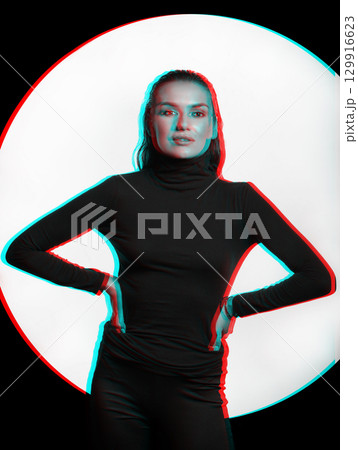 Woman with black turtle neck sweater, tight trousers and wet hair style studio portrait in RGB color split effect 129916623