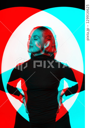 Woman with black turtle neck sweater, tight trousers and wet hair style studio portrait in RGB color split effect Woman with black turtle neck sweater, tight trousers and wet hair style studio portrait in RGB color split effect 129916625