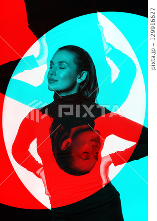 Woman with black turtle neck sweater, tight trousers and wet hair style studio portrait in RGB color split effect 129916627
