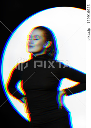 Woman with black turtle neck sweater, tight trousers and wet hair style studio portrait in RGB color split effect Woman with black turtle neck sweater, tight trousers and wet hair style studio portrait in RGB color split effect 129916628