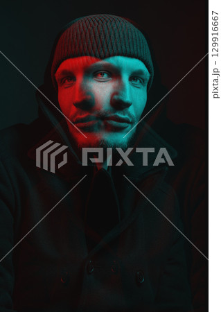 Serious man with black winter coat and winter hat studio portrait in glitch and RGB color split effect style 129916667