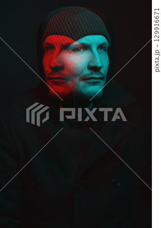 Serious man with black winter coat and winter hat studio portrait in glitch and RGB color split effect style 129916671