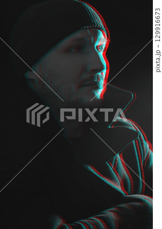 Serious man with black winter coat and winter hat studio portrait in glitch and RGB color split effect style 129916673