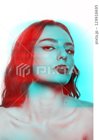 Beautiful woman with wavy long hair and makeup studio portrait in RGB color split effect style 129916695