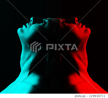 Beautiful woman face silhouette portrait illuminated with light in RGB color split effect style and dark background 129916711