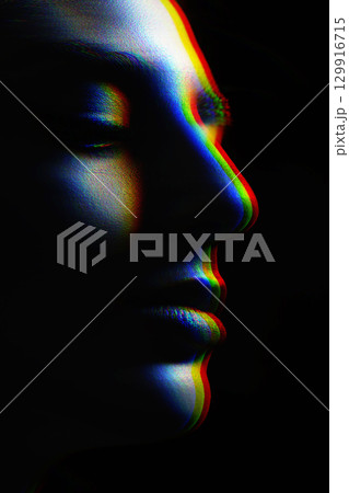 Beautiful woman face silhouette portrait illuminated with light in RGB color split effect style and dark background 129916715