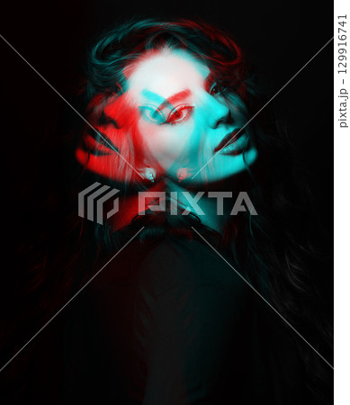 Woman with long wavy hair sensual studio portrait in RGB color split effect style 129916741