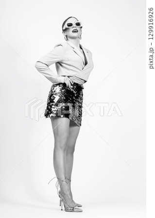 Woman studio black and white portrait with jacket and mini skirt Woman studio black and white portrait with jacket and mini skirt 129916926