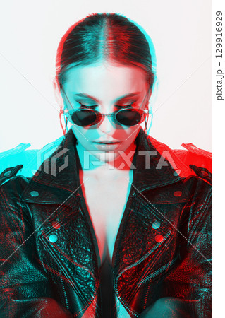 Woman studio portrait with black punk leather jacket, sunglasses and without bra in RGB color split effect style Woman studio portrait with black punk leather jacket, sunglasses and without bra in RGB color split effect style 129916929