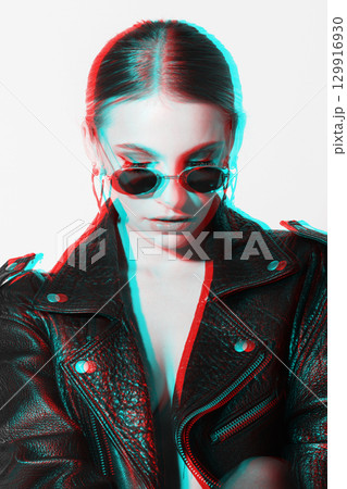 Woman studio portrait with black punk leather jacket, sunglasses and without bra in RGB color split effect style Woman studio portrait with black punk leather jacket, sunglasses and without bra in RGB color split effect style 129916930