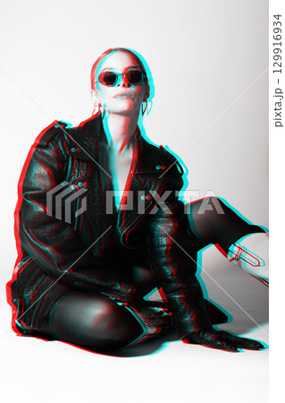 Woman studio portrait with black punk leather jacket, sunglasses and without bra in RGB color split effect style Woman studio portrait with black punk leather jacket, sunglasses and without bra in RGB color split effect style 129916934