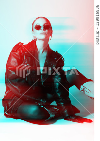 Woman studio portrait with black punk leather jacket, sunglasses and without bra in RGB color split effect style Woman studio portrait with black punk leather jacket, sunglasses and without bra in RGB color split effect style 129916936