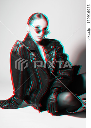 Woman studio portrait with black punk leather jacket, sunglasses and without bra in RGB color split effect style 129916938