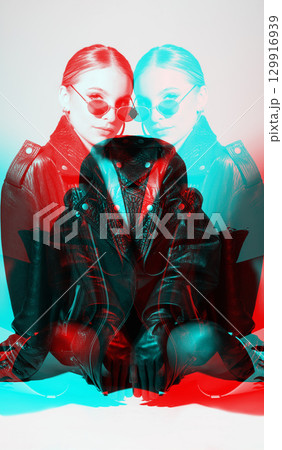 Woman studio portrait with black punk leather jacket, sunglasses and without bra in RGB color split effect style Woman studio portrait with black punk leather jacket, sunglasses and without bra in RGB color split effect style 129916939