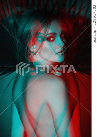 Beautiful woman with naked back and palm leaf studio portrait in RGB color split effect style 129917302
