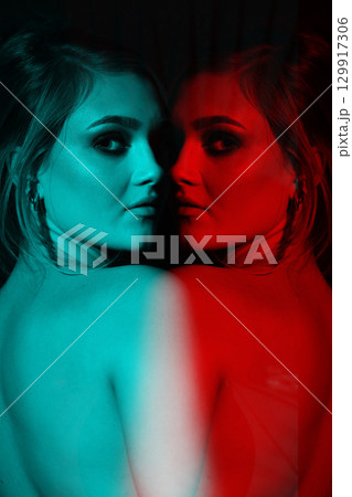 Beautiful woman with naked back and palm leaf studio portrait in RGB color split effect style 129917306