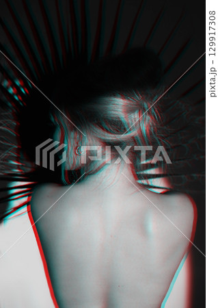 Beautiful woman with naked back and palm leaf studio portrait in RGB color split effect style 129917308
