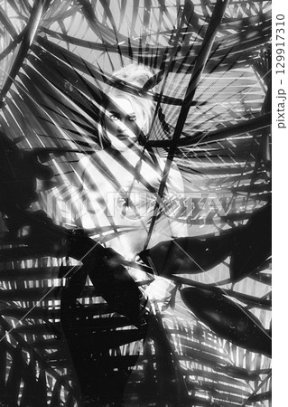 Beautiful woman with shining corset standing in jungles abstract collage portrait 129917310