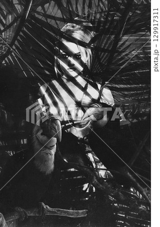 Beautiful woman with shining corset standing in jungles abstract collage portrait 129917311