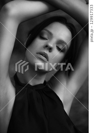 Tranquil Portrait of a Woman in Nature 129917333