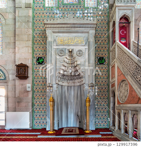 Interior of Burunguz Mosque, Kayseri, Turkey, featuring Mihrab, Minbar, and ornate ceramic tiles with floral patterns 129917396