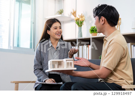 Real Estate Consultation: Agent Discussing Model Home with Client 129918497