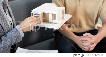 Real Estate Agent Explaining Model Home Features to Client 129918504