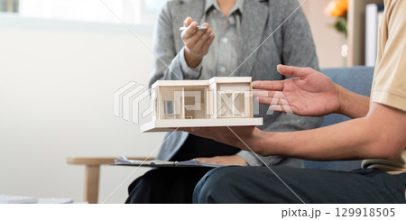 Real Estate Agent Presenting Model Home to Client 129918505