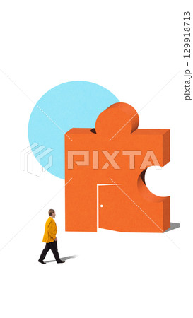 Minimalist collage of businessman walking toward orange puzzle block with doorway 129918713