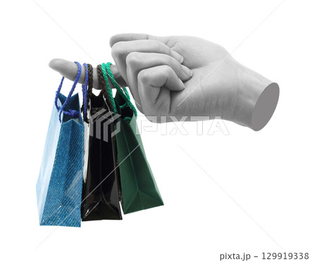 Hand holds mini shopping bag, isolated on transparent background, shopping concept. Contemporary art design 129919338