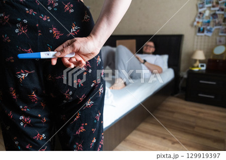 Positive Pregnancy Test Hidden Behind Back 129919397