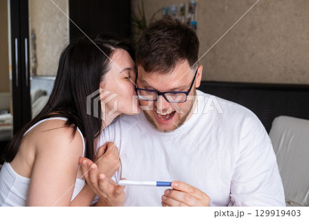 Happy Couple Celebrating Positive Pregnancy Test 129919403