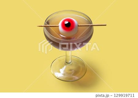 Halloween cocktail garnished with candy eye Halloween cocktail garnished with candy eye 129919711