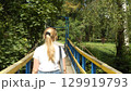 A woman in the park on a bridge 129919793