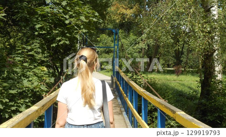 A woman in the park on a bridge 129919793