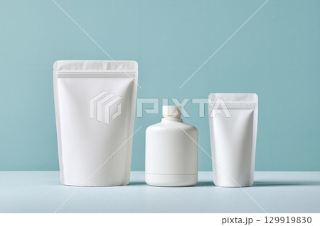 white cosmetic pouch container on blue 129919830