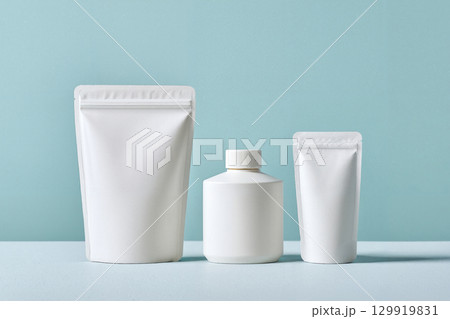white pouch cosmetic container on blue 129919831