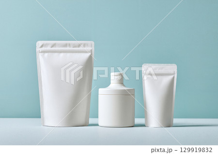 white pouch cosmetic container on blue 129919832