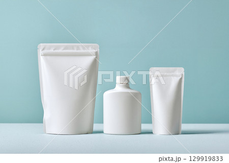 white pouch cosmetic container on blue 129919833