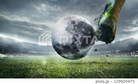 Bright collage soccer player kicking moon ball on stadium field Bright collage soccer player kicking moon ball on stadium field 129920473