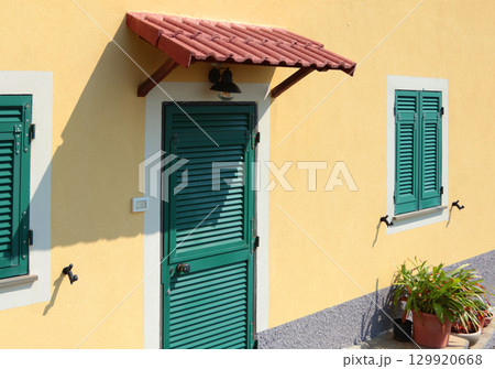 Traditional green doors and windows of Liguria. Tiled canopy. Traditional buildings of Italy. Copy space for design. Traditional green doors and windows of Liguria. Tiled canopy. Traditional buildings of Italy. Copy space for design. 129920668