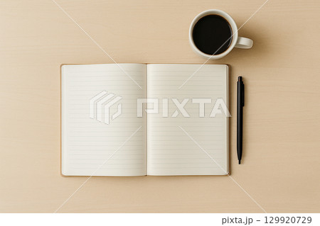 Open lined notebook with coffee and pen on light wooden desk, top view 129920729