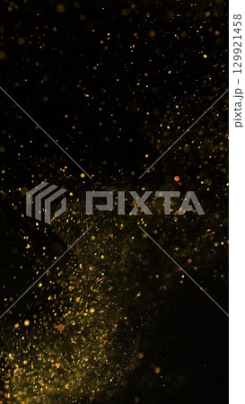 Freeze Motion Shot of Golden Glitter Background Isolated on Black 129921458